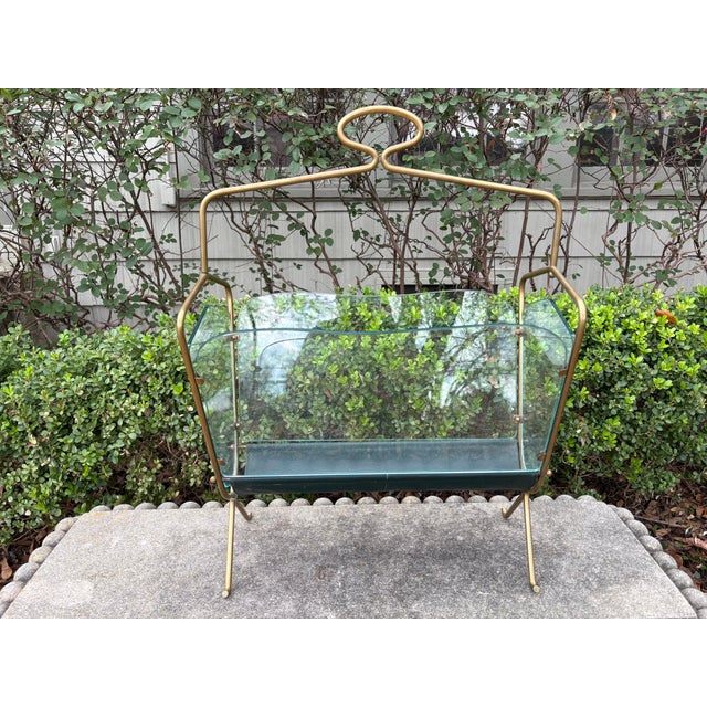Italian Modern Brass And Glass Magazine Holder. Offered is a stylish Italian mid century modern brass, glass and leather...