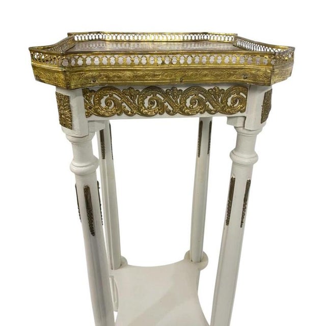 An elegant French Belle Epoque pedestal stand, dating to the late 19th century, beautifully decorated in painted ivory-...
