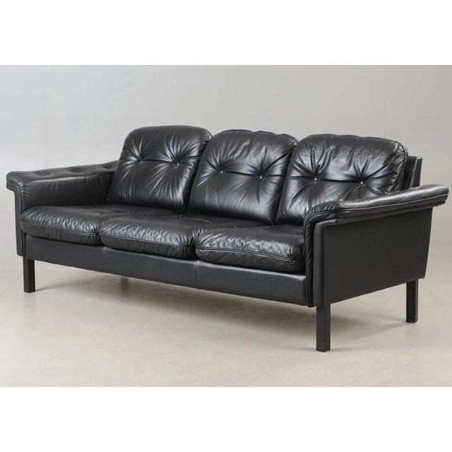 Vintage Danish Mid-Century Black Buttoned Leather 3-Seater Sofa 1975 A beautiful Danish-made sofa upholstered in soft,...