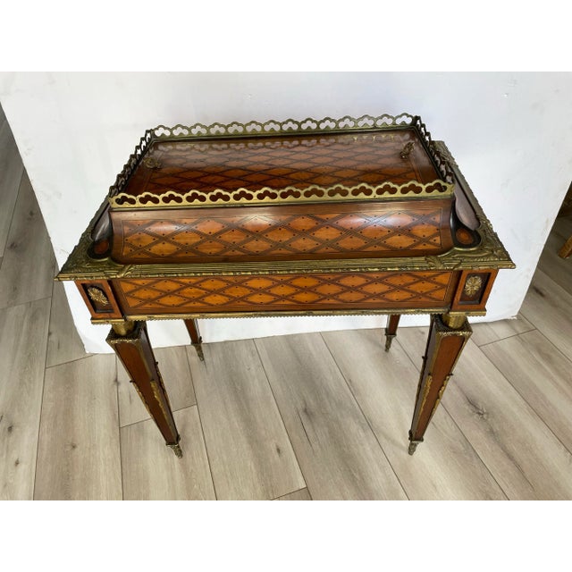 This Antique French Louis XVI Inlaid Jardiniere side table with brass/bronze mounts exudes a sense of opulence and...