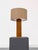 Decorative table lamp consisting of a teak wood base and a shade made of natural woven material. Includes a cable with a...