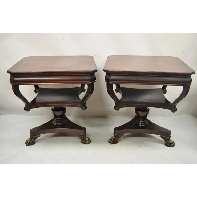 Vintage French Empire Style Mahogany 2 Tier Paw Feet Side End Tables - a Pair. Item features a claw foot tripod pedestal...