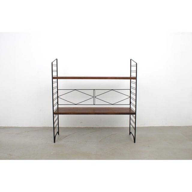 Free standing shelves produced by Home & Garden in the 60s. Lacquered metal frame, brass supports, wooden shelves with...