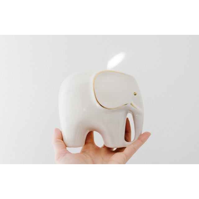 Gorgeous Mid-Century Modern ivory and gold porcelain elephant set expertly handcrafted in Germany. Sleek, modern glazed...