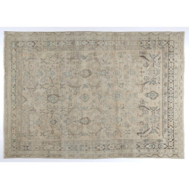 This near-antique Persian rug is a stunning example of traditional craftsmanship, hand-knotted in wool on a cotton...