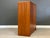 A mid century modern teak armoire dresser with brass drawer pulls. Push to open door. Made in Denmark. 45.5” wide. 18”...