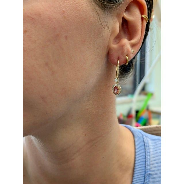 Indulge in refined luxury with this masterfully crafted pair of drop earrings. Featuring 1.19 carats of mesmerizing...