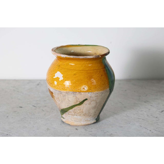 This 19th-century Spanish pottery jar showcases the rustic charm and artistic flair of traditional Mediterranean...