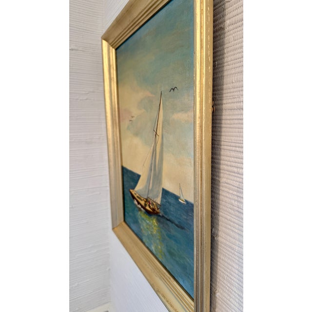 Stunning vintage mid-century original oil painting depicts sailboats gliding across open water beneath a soft sky with...