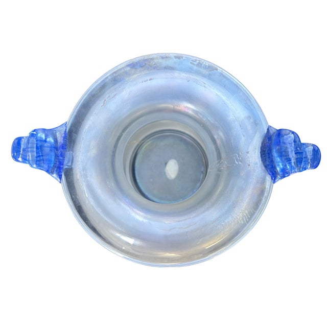 Hand-blown Murano art glass vase featuring a classic amphora form with applied cobalt blue scroll handles. The surface...