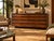 A John Stuart low dresser featuring warm wood and contrasting dark details. Its long, clean-lined design offers eight...