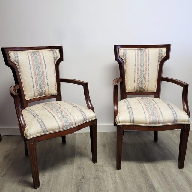 A refined pair of early 20th-century American mahogany armchairs designed in the Federal tradition, drawing inspiration...