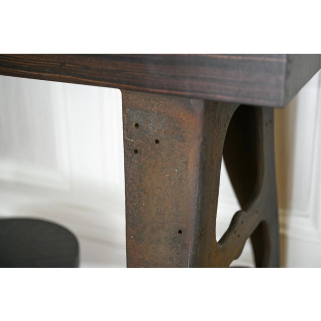 A bold blend of industrial character and fine woodworking, this custom console table features a richly figured Macassar...