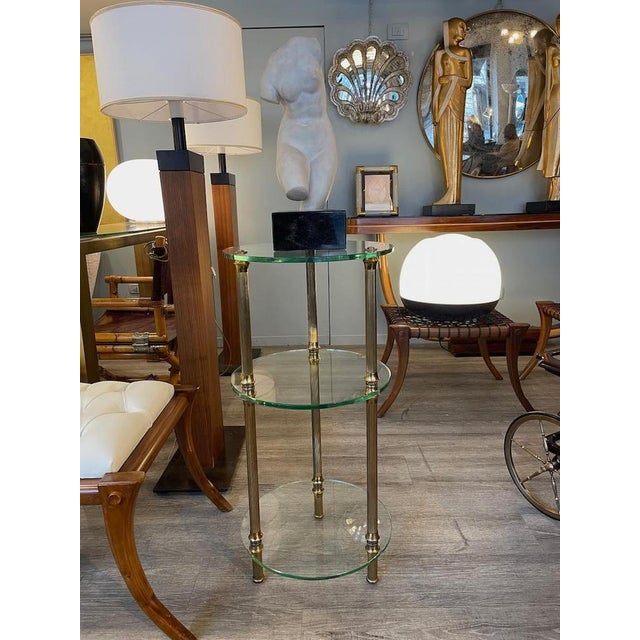 Rare 1950s side table of great elegance and versatility. Featuring a light and refined structure, it has three transparent...
