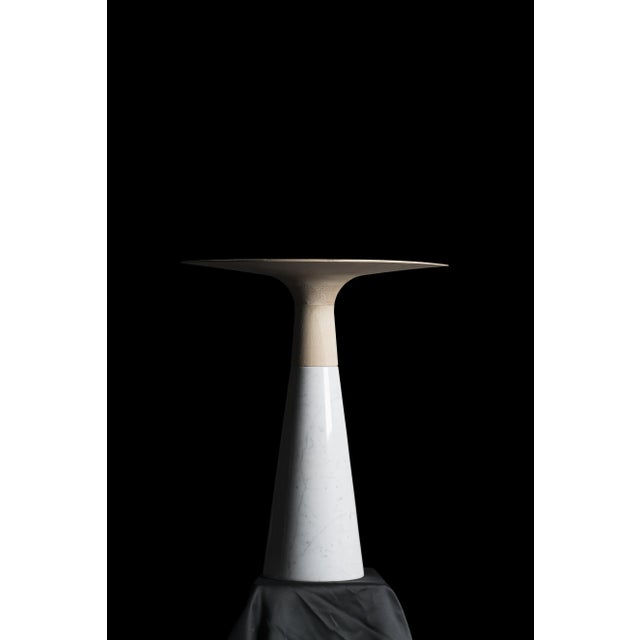 <p><em>Luna</em> is a small table in white Carrara marble and natural wood made of solid wood. Its elegant but minimalist...