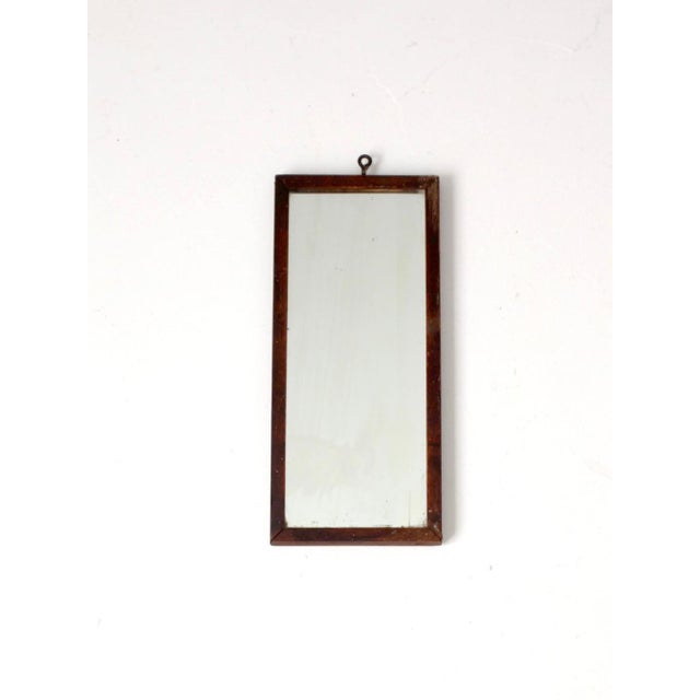Antique 19th-century double reflection mirror with a slender wood frame, beautifully aged surface, and simple metal ring...