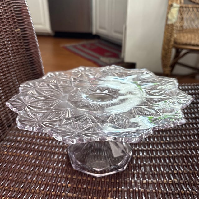 Sun Purple Cake Pedestal in the Shoshone Pattern circa 1896. This is a small pedestal 9 1/2"W x 4"H. Sun Purple glass...