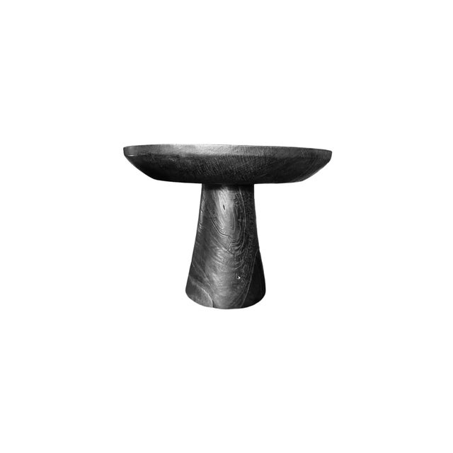 A wonderfully organic round side table. Its rich black pigment was achieved through burning the wood three times. Its...