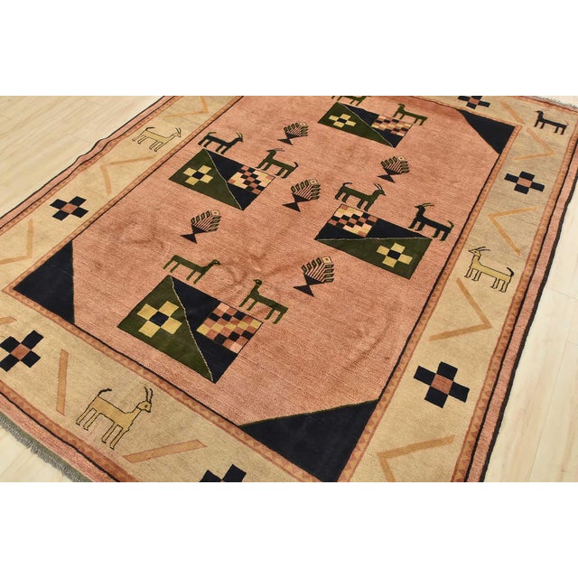 This tribal geometric Gabbeh rug is hand-knotted with an all-wool pile on a wool foundation. This rug is new and in...