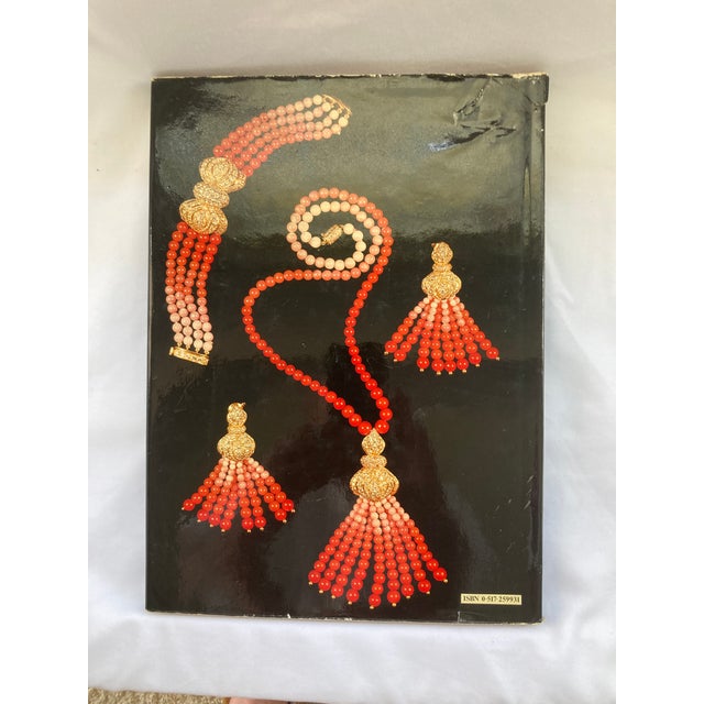A 13 x 9.5 Hardbound Coffee Table Book with Original Jacket. Its 94 oversized pages presents the history of jewelry with...
