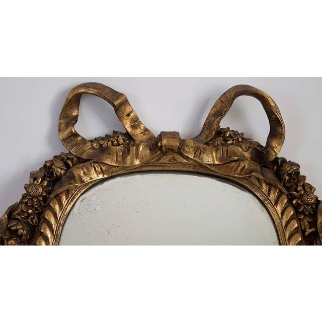 Stunning antique gold gilt mirror. The bow tie accent at the top is truly unique. Age & origin is estimated