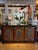 Large Asian credenza, storage cabinet with 3 doors. Lots of storage. Cabinet has a distressed wood finish with ornate...
