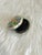 A vintage, oval-shaped, lidded lacquer box with black interior and intricately painted blue, pink, and purple floral...
