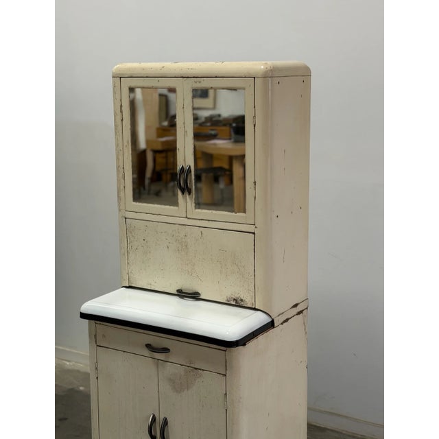 W26 D20.5 D12 H66 This vintage aged medical cabinet features an enamel work surface and mirrored glass doors, and ample...