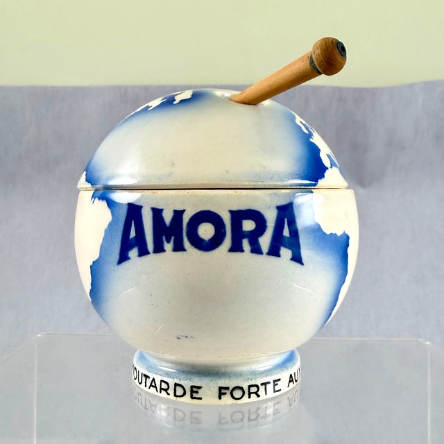 An earthenware Amora moutardier, or mustard pot, with a wooden serving paddle, made by Digoin Sarreguemines, circa 1930s –...
