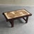 Striking mid-century modern coffee table featuring hand-painted ceramic tiles signed by artist Jean D'Asti a French...