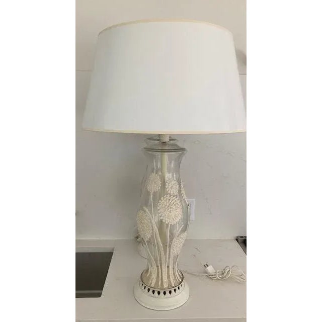 These are large impressive lamps from the 60's. They are clear glass with hand applied ceramic fflowers.