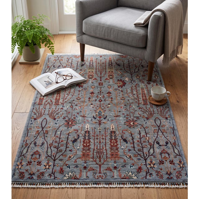 This hand-knotted wool rug was woven in northern Afghanistan by Turkmen weaving families working in the Persian Bidjar and...