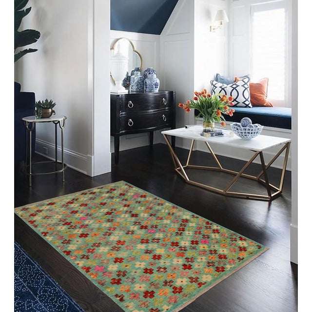 This stunning hand-knotted Afghan Balouchi rug is a captivating addition to any decor. Crafted by skilled artisans, it...