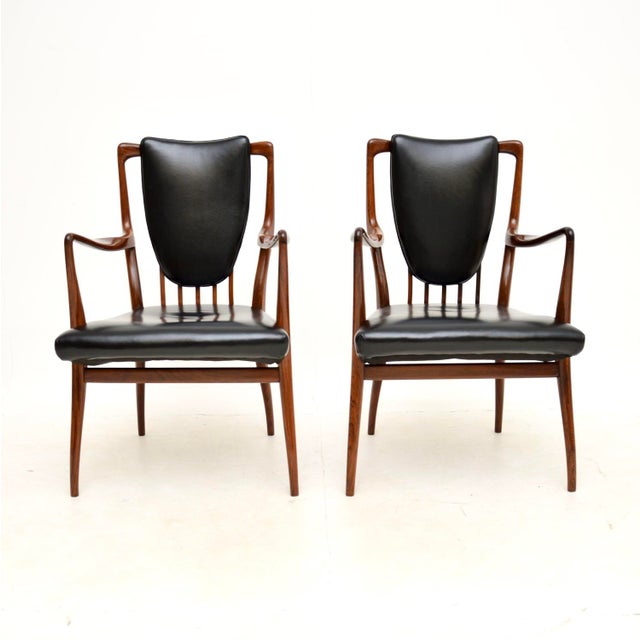 An absolutely stunning and very rare pair of carver chairs by Andrew Milne. They were designed in the 1940’s for Heal’s,...
