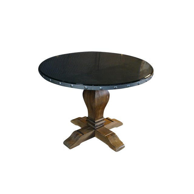 This round dining table combines rustic charm with industrial flair, featuring a carved acacia wood pedestal base and a...