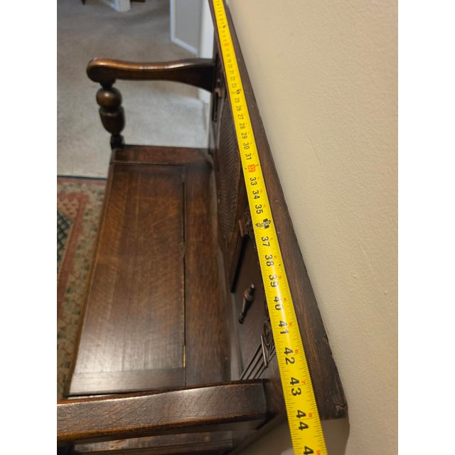 English Antique Oak Hall Bench Features Intricate Carvings and a Circular Cane Insert in the Backrest, Late 19th Century For Sale - Image 3 of 9