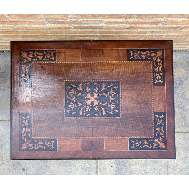 19th century Baroque Spanish side table with marquetry top 19th century Spanish trestle table in walnut. This piece has a...