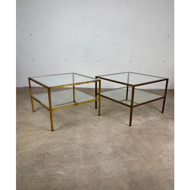 Pair of Brass and Glass Side Tables A sophisticated pair of side tables featuring an elegant brass frame and glass tops,...