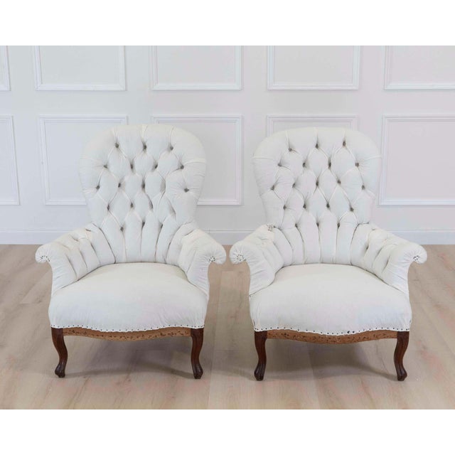 Striking pair of French high back chairs dating from the early 20th century. Featuring elegant proportions and a...