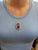 This dramatic statement pendant showcases a vivid 22-carat emerald-cut Zambian amethyst (27.5x18.5mm), wrapped in a...