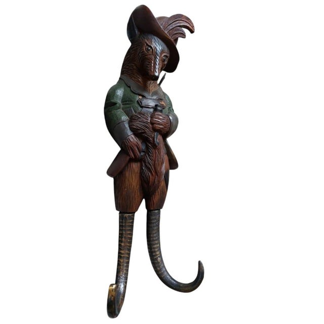 Sculpture carved from oak of a fox dressed as a hunter with a rifle. (Black Forest). Was originally made as a whip holder....