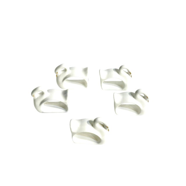 Charming set of 5 white ceramic swan napkin rings with gilt detailing. Each face has been drawn out in delicate gold....