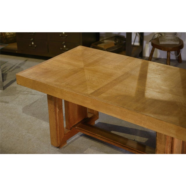 A powerful oak dining table, typical of french furniture production in the 1940s. A large, thick top with clean edges...