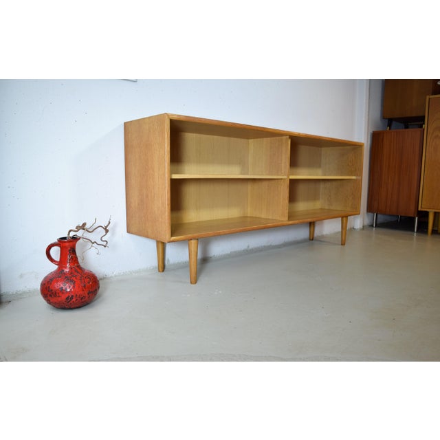 This is an open WK Möbel sideboard from the 1960s. The sideboard features a high-quality oak veneer with an authentic...