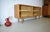 This is an open WK Möbel sideboard from the 1960s. The sideboard features a high-quality oak veneer with an authentic...