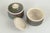 John Andersson for Höganäs, pair of lidded jars. Pair of thrown stoneware lidded jars with cylindrical bodies and fitted...
