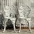 This charming vintage Regency-style wrought iron set includes a round table and two matching chairs, all featuring...