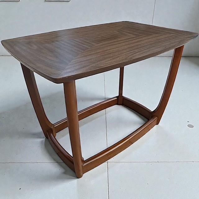 This vintage Mid-Century Modern end table dates to the 1960s and features a striking geometric-patterned laminate top...