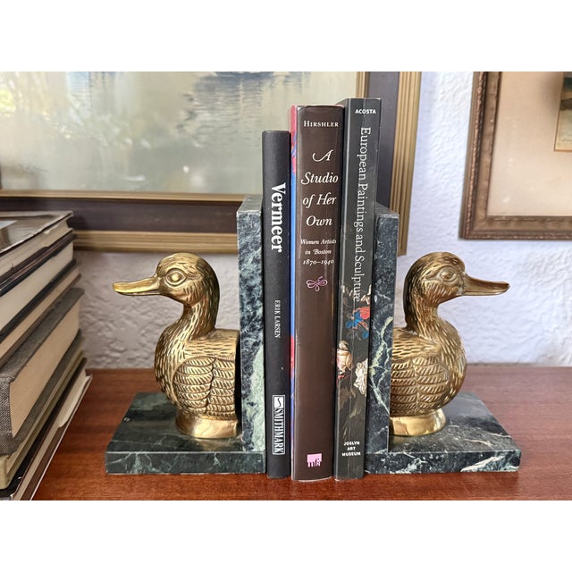 Late 20th century solid brass duck bookends on black and green marble. A heavy and attractive pair. Most items found at...