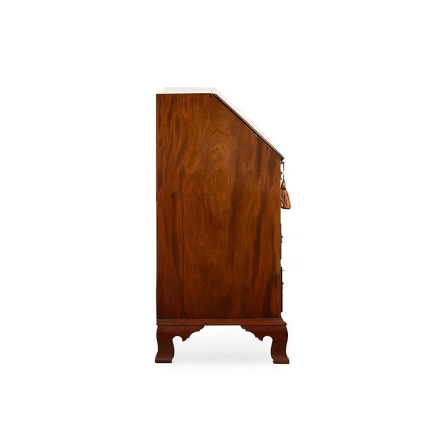An elegant early 20th-century American Chippendale style mahogany slant front secretary desk featuring beautifully figured...
